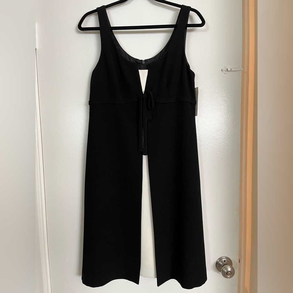 TERI JON. White crepe sheath dress with attached black fly away sleeveless coat.